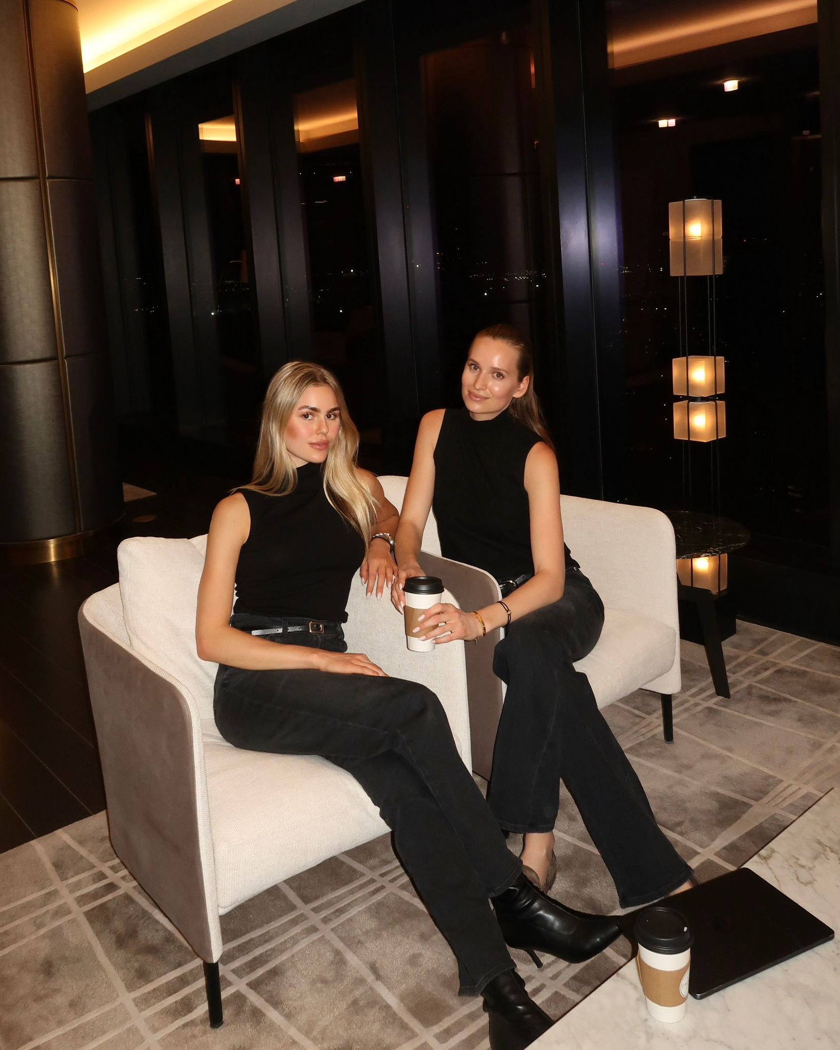 Giulia and Lisa, the founders of Extra Shot NYC, sitting together with a coffee